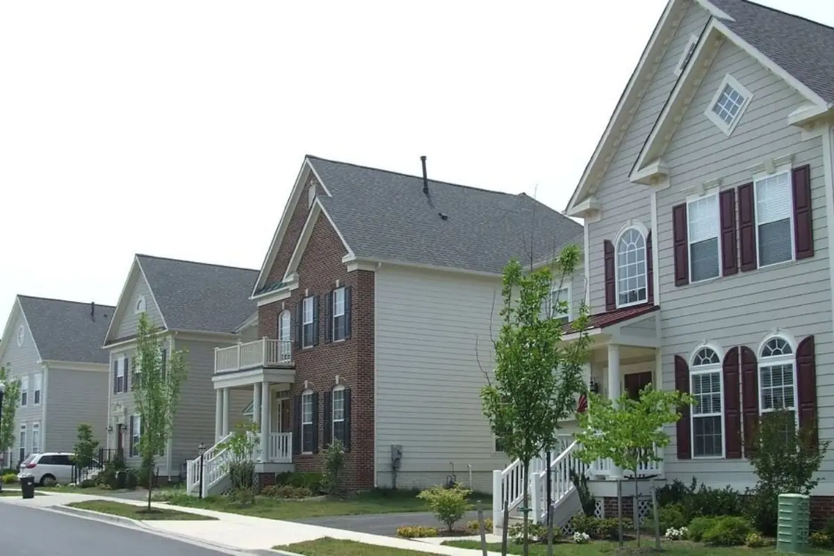 Newer brick and siding homes along a tree-lined street in a planned community