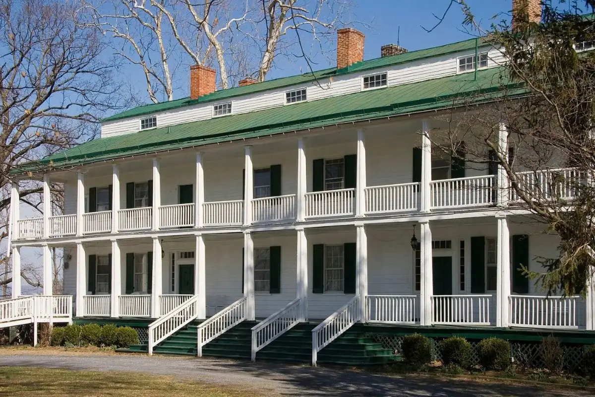 Historic Maryland house with a two-story columned porch and green roof